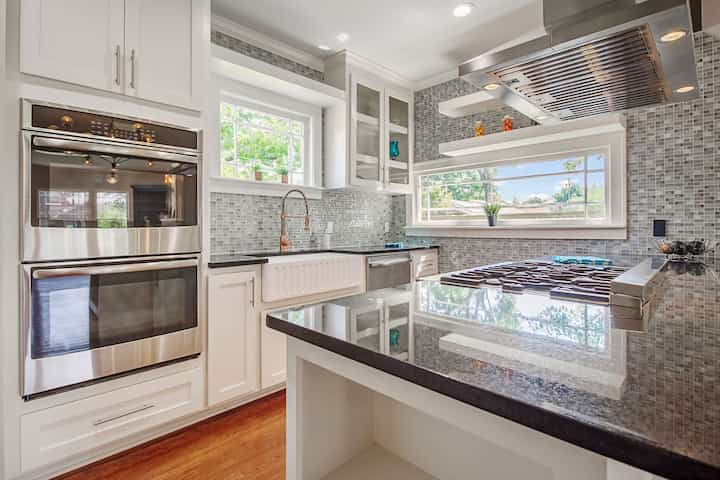 An image of a modern kitchen with sleek appliances, featuring a gas stove, refrigerator, and built-in microwave in Virginia beach